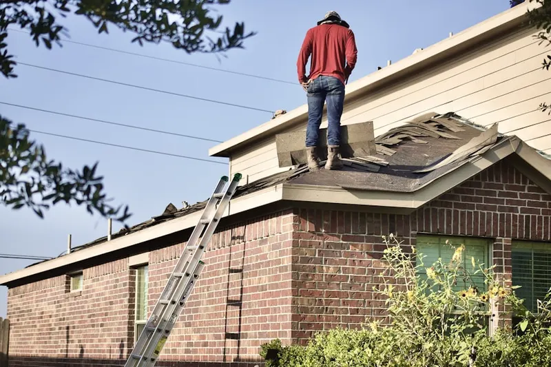 Professional roofer working on a residential roof in Plainfield